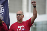 File - United Auto Workers President Shawn Fain raises his fist at a rally in Detroit, on Sept. 15, 2023. Armed with a list of what even Fain called “audacious” demands for better pay and benefits, the UAW leader has embodied the exasperation of workers who say they've struggled for years while the automakers have enjoyed billions in profits. (AP Photo/Paul Sancya, File)