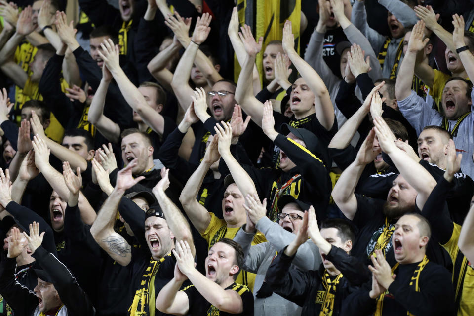Dortmund's supporters react after Raphael Guerreiro scored his side first goal during the Champions League group A soccer match between AS Monaco and Borussia Dortmund, in Monaco, Tuesday, Dec. 11, 2018. (AP Photo/Claude Paris)