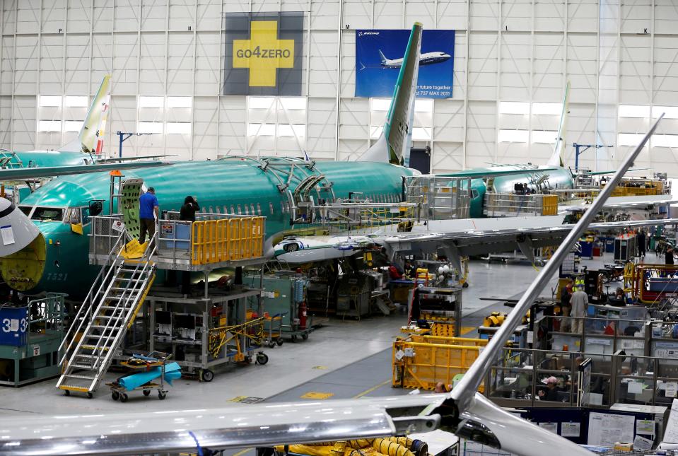 People work near the door of a 737 Max aircraft at the Boeing factory in Renton, Washington, U.S., March 27, 2019.