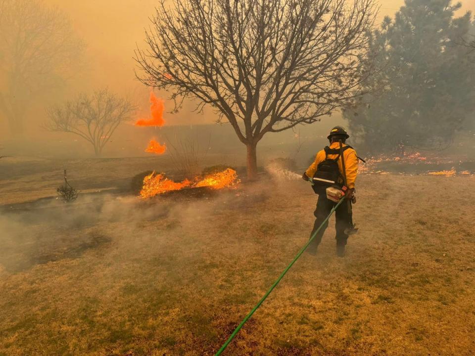 This handout picture courtesy of the Flower Mound Fire Department taken on February 28, 2024, shows a firefighter battling the Smokehouse Creek Fire, near Amarillo, in the Texas Panhandle. (Flower Mound Fire Department/AFP)