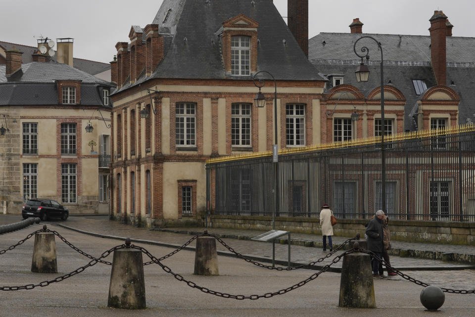 A mosaic by French artist Invader, left background, is seen on a street of Fontainebleau, south of Paris, Thursday, Feb. 29, 2024. For the Paris Olympics, it could almost have been a new sport: Score points by scouring France's capital for mosaics that a mystery artist who calls himself "Invader" has cemented to walls across the city, across the world and even had carried aloft to the International Space Station. (AP Photo/Thibault Camus)