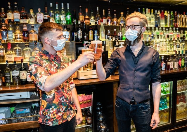 Barr staff celebrate in the Showtime Bar at midnight in Huddersfield (Danny Lawson/PA)