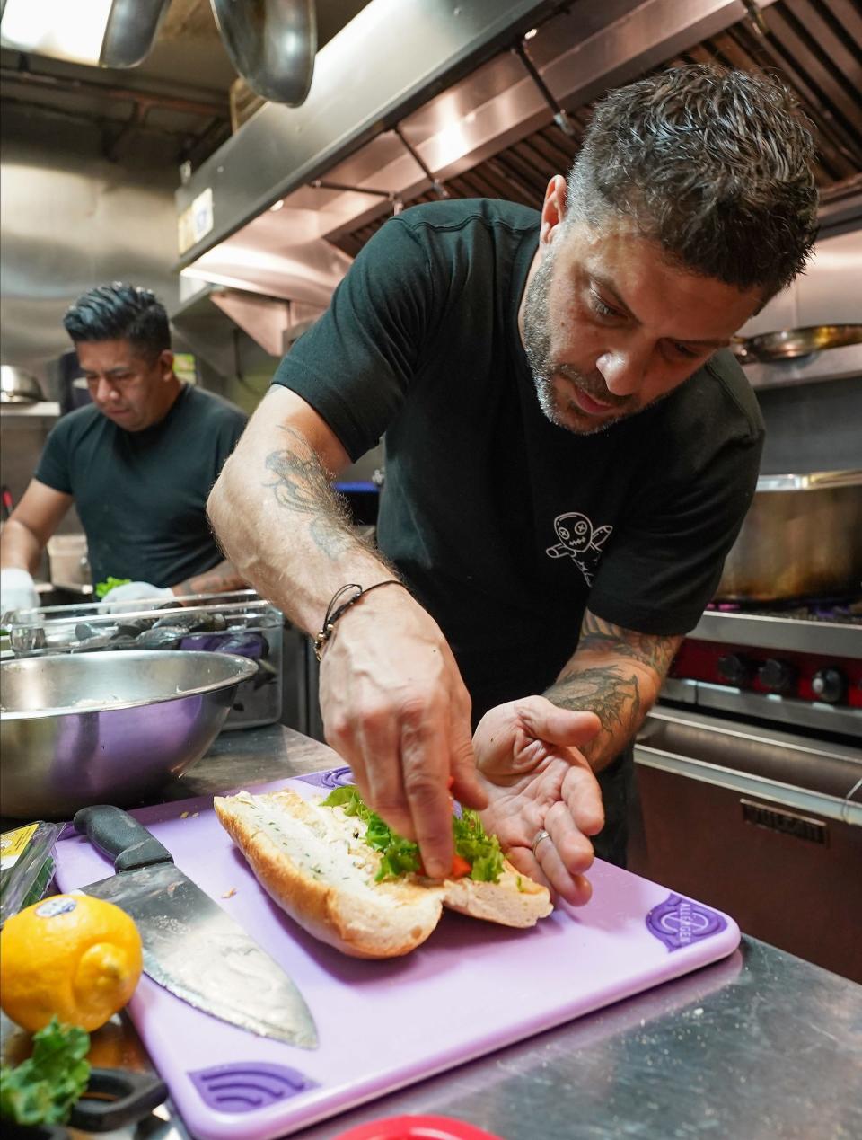 Chef Michael Boulos prepares a dish in the kitchen of Crawdaddy's Creole Kitchen in Pleasantville on Thursday, November 2023.