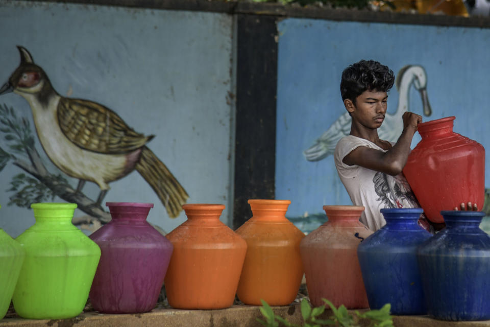 A boy carries water cans being filled at the Metro water filling station in the heart of Chennai on June 30, 2019. All four major reservoirs supplying water to the city had dried up. (Photo: Atul Loke via Getty Images)