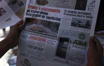 In this Saturday, Aug. 31, 2019, photo, An Afghan man reads a local newspaper about peace in Kabul, Afghanistan. For almost a year, Afghanistan’s more than 30 million people have been in the awkward position of waiting as a United States envoy and the Taliban negotiate their country’s fate behind closed doors. An agreement on ending America’s longest war, which the U.S. once hoped to reach by Sunday, Sept. 1, not only could set a timeline for U.S. troops’ withdrawal but also nudge aside this month’s presidential election and open the way for a Taliban return to power. (AP Photo/Rahmat Gul)