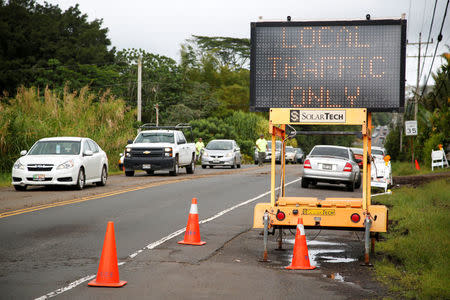 Residents of the Puna District pass a highway control point in the town of Pahoa. REUTERS/Terray Sylvester