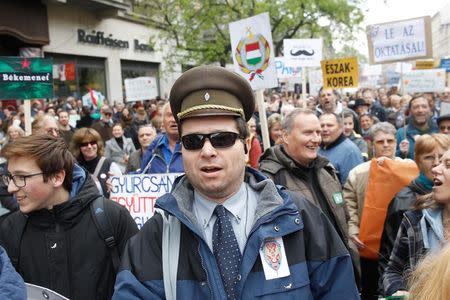 Hungarians protest against the rightwing government at a rally organised by spoof Two-tailed Dog Party in Budapest, Hungary, April 22, 2017. REUTERS/Bernadett Szabo