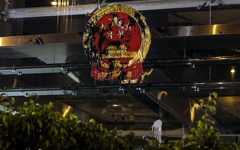 The Liaison Office's Chinese emblem was defaced - Credit: Bloomberg
