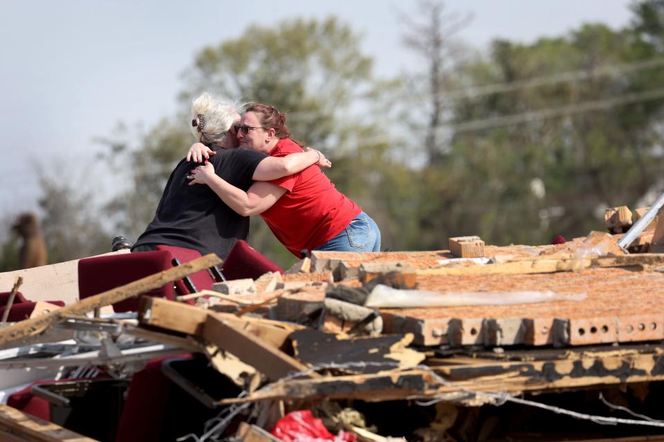 Women hug among the rubble of a home as cleanup continues in the aftermath of Friday's tornado on March 28, 2023 in Rolling Fork, Mississippi. At least 26 people died when an EF-4 tornado ripped through the small town and nearby Rolling Fork on Friday evening.