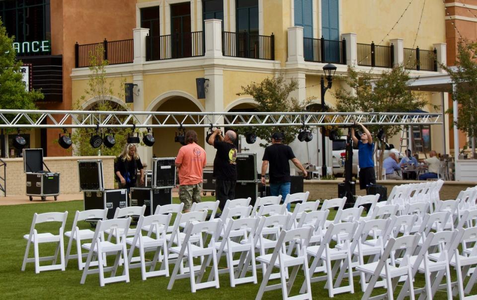 Workers set up lighting for the musicians who will perform Thursday night's performance at Sundown at Renaissance.