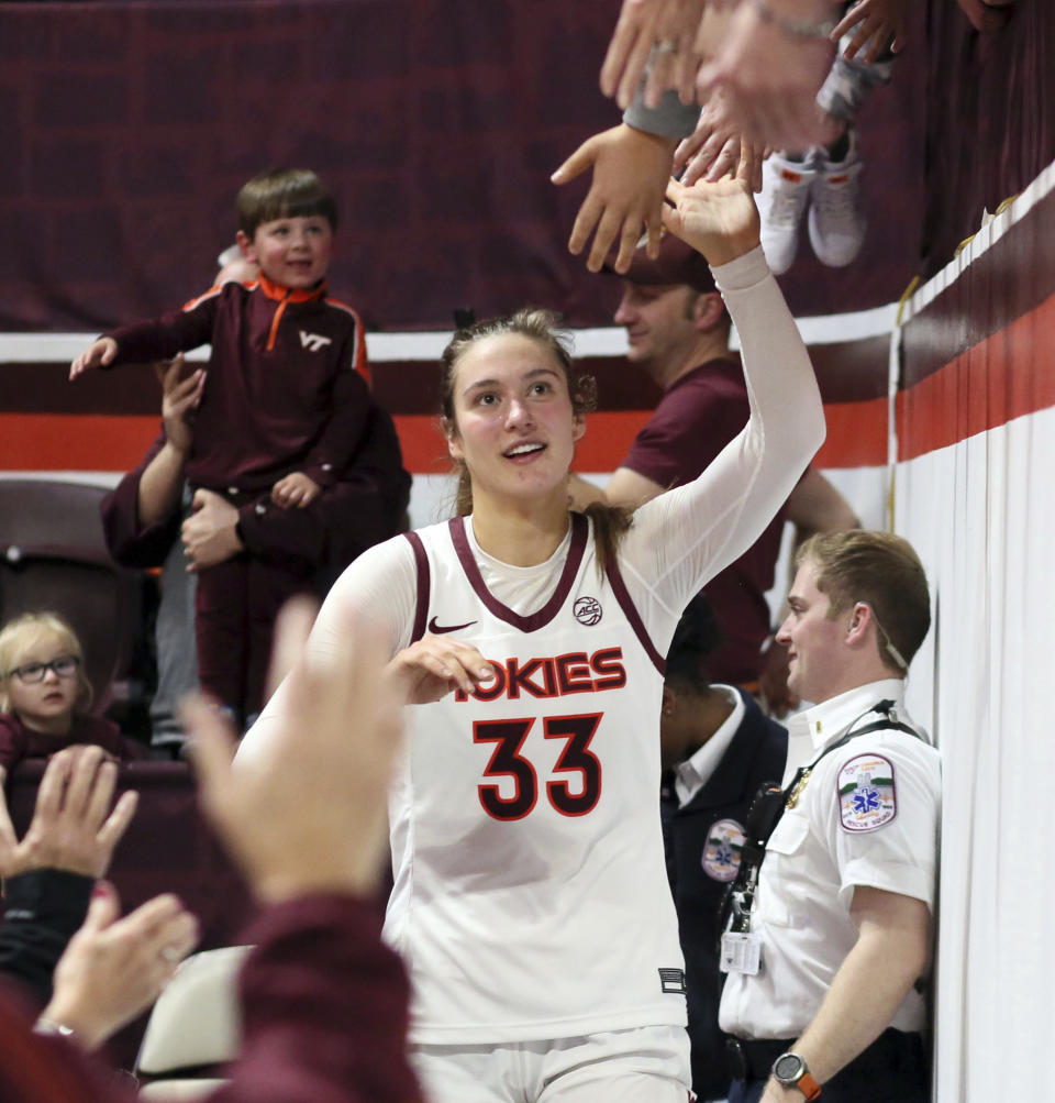 Virginia Tech's Elizabeth Kitley (33) celebrates with fans after the team's win over North Carolina State in an NCAA college basketball game Sunday, Feb. 19, 2023, in Blacksburg, Va. (Matt Gentry/The Roanoke Times via AP)