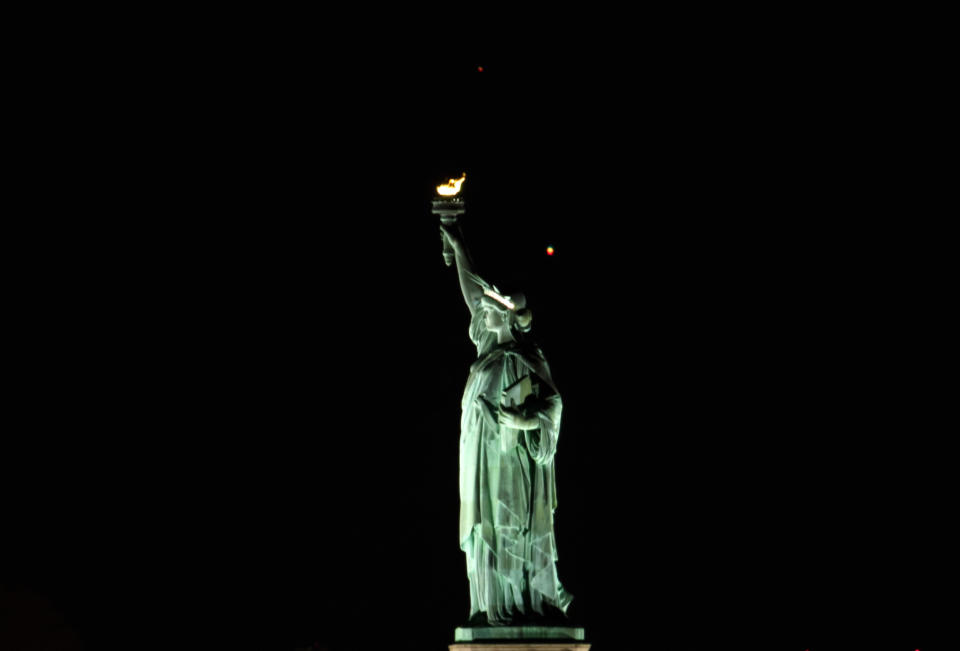 Saturn and Jupiter set behind the Statue of Liberty ahead of their conjunction, on December 17, 2020, in New York City. / Credit: Gary Hershorn / Getty Images