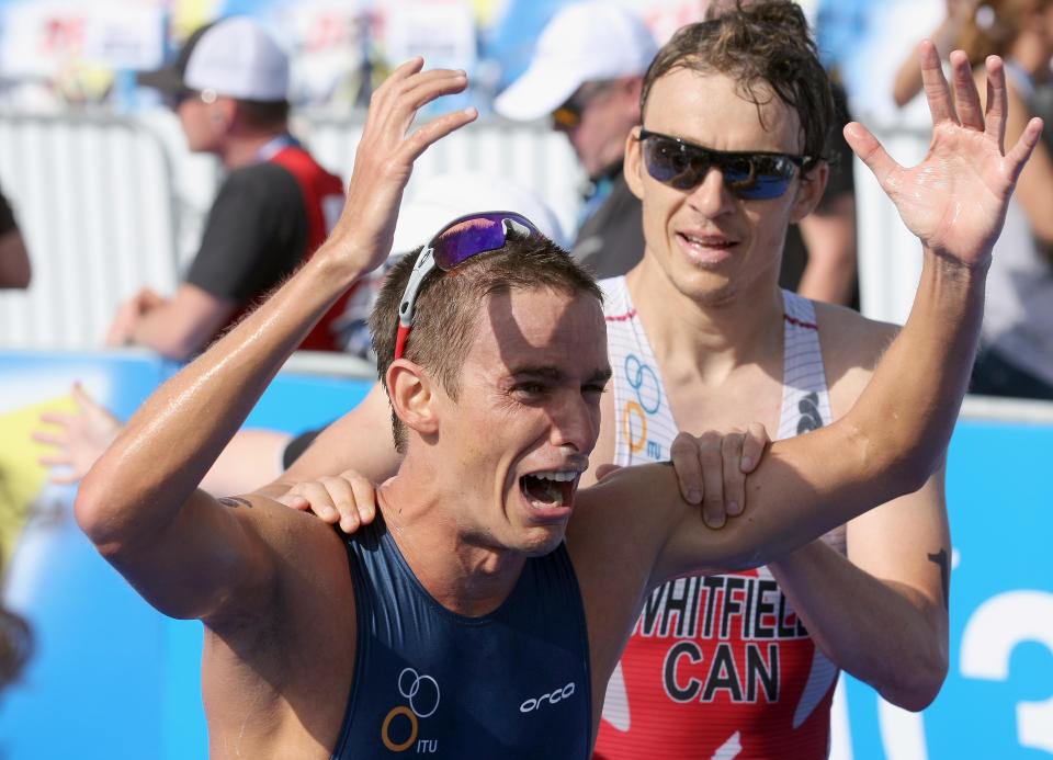SAN DIEGO, CA - MAY 12: Manuel Huerta of the USA is congratulated by Simon Whitfield of Canada after Huerta's 9th place finish and Olympic birth during the 2012 ITU World Triathlon San Diego Elite Men's Race on May 12, 2012 in San Diego, California. (Photo by Donald Miralle/Getty Images)