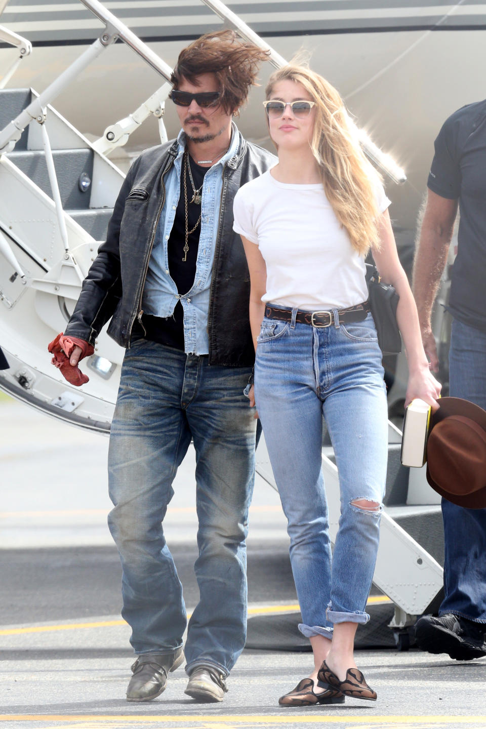 American actor Johnny Depp and wife Amber Heard arrive on a private jet at Brisbane Airport on April 21, 2015 in Brisbane, Australia.