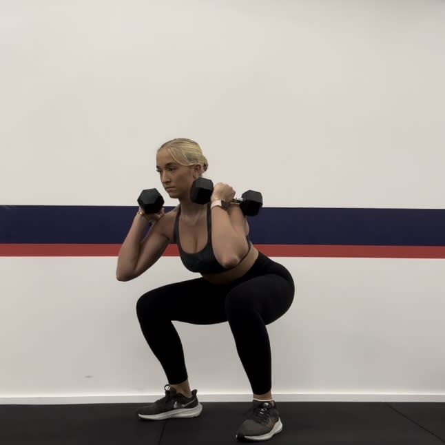 Personal trainer Klaudia Lucia demonstrating a squat to press