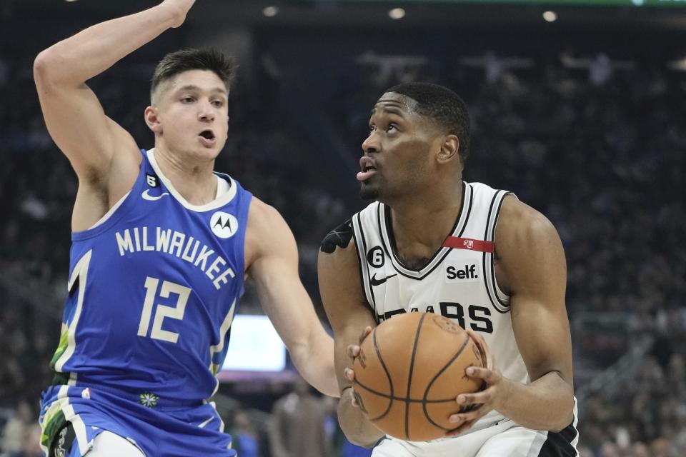 San Antonio Spurs' Malaki Branham looks to shoot in front of Milwaukee Bucks' Grayson Allen during the first half of an NBA basketball game Wednesday, March 22, 2023, in Milwaukee. (AP Photo/Morry Gash)