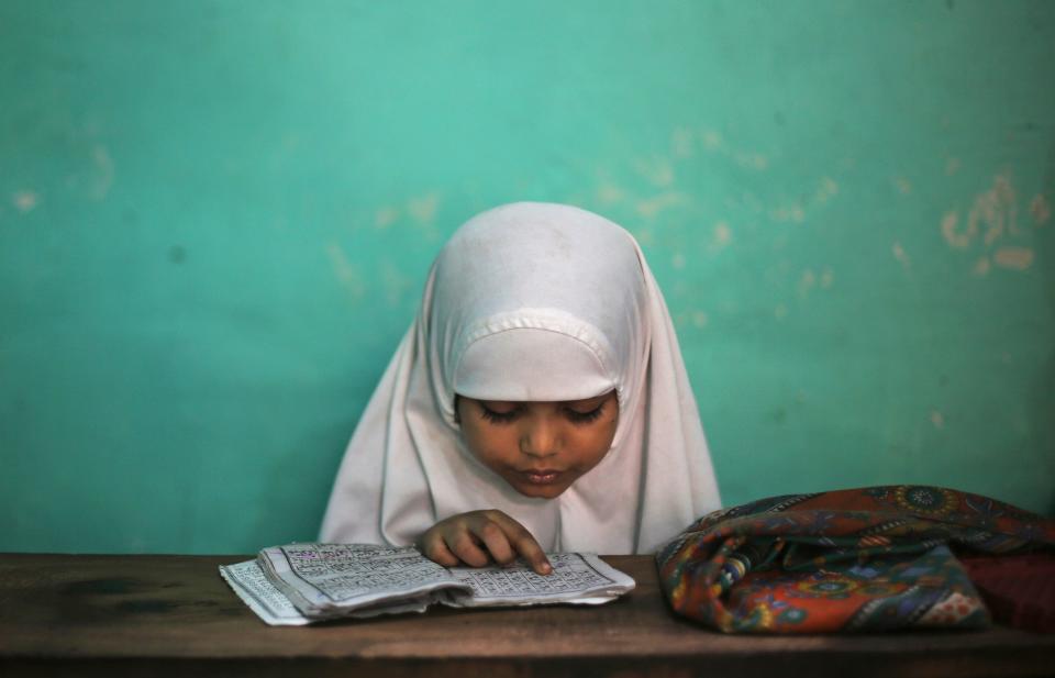 May 22, 2018: A young Indian Muslim girl learns to read the Quran at a madrasa during the holy Muslim month of Ramadan in New Delhi, India.