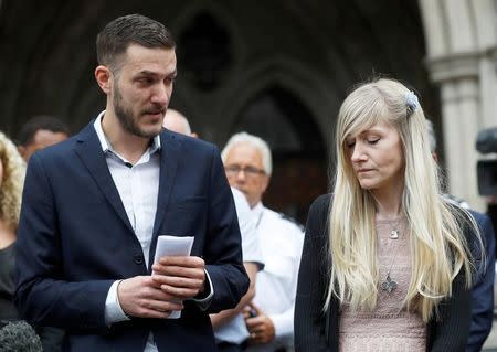 FILE PHOTO: Charlie Gard's parents Connie Yates and Chris Gard read a statement at the High Court after a hearing on their baby's future, in London, Britain July 24, 2017. REUTERS/Peter Nicholls