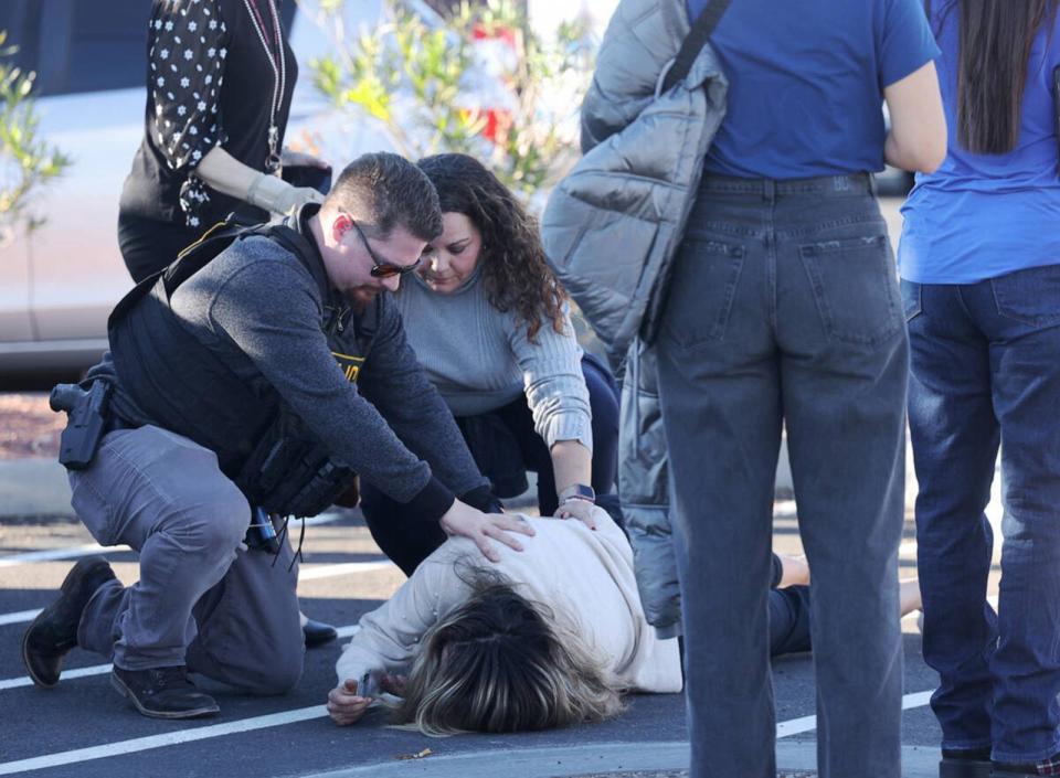 PHOTO: Police attend to a person near Maryland Parkway following a shooting on the UNLV campus, Dec. 6, 2023, in Las Vegas.  (K.M. Cannon/Las Vegas Review-Journal/Tribune News Service via Getty Images)