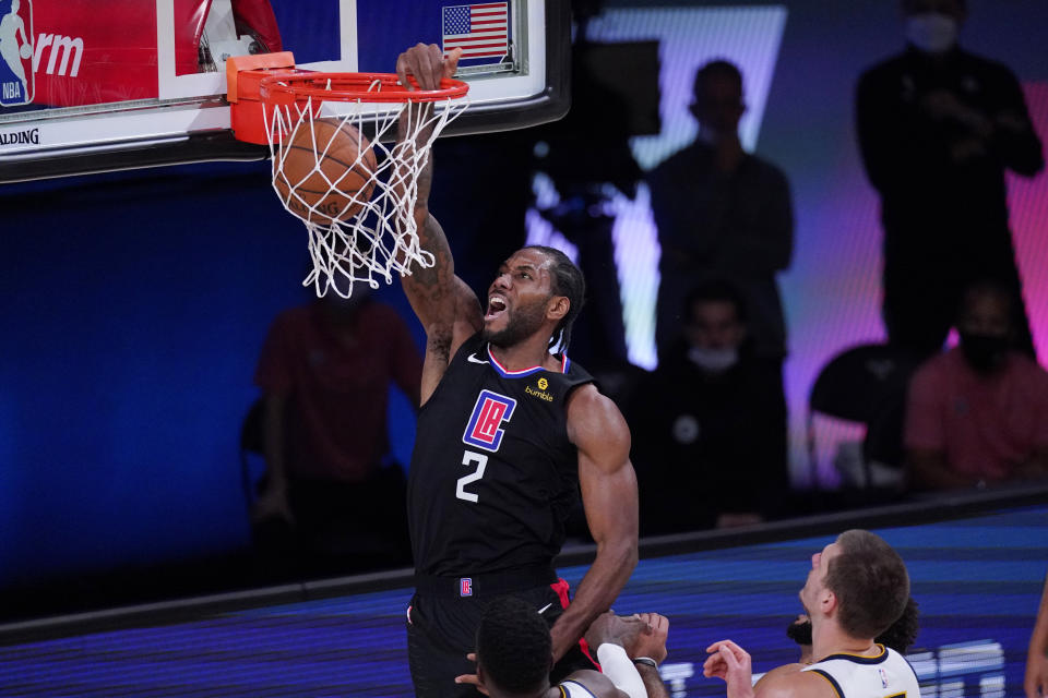 Los Angeles Clippers forward Kawhi Leonard (2) scores against the Denver Nuggets during the first half of an NBA conference semifinal playoff basketball game Tuesday, Sept. 15, 2020, in Lake Buena Vista, Fla. (AP Photo/Mark J. Terrill)