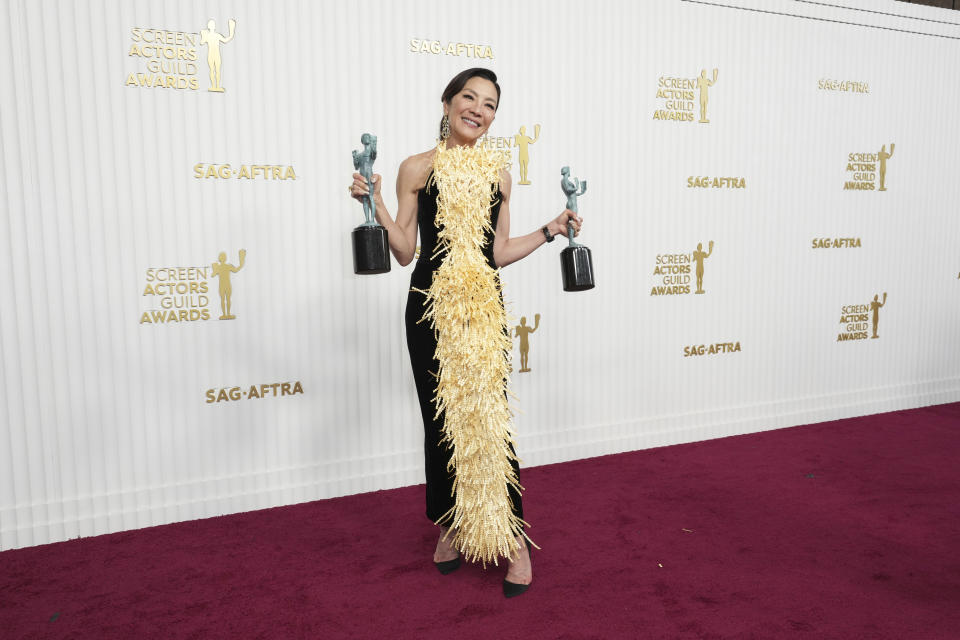 Michelle Yeoh poses in the press room with the awards for outstanding performance by a female actor in a leading role, and outstanding performance by a cast in a motion picture for "Everything Everywhere All at Once" at the 29th annual Screen Actors Guild Awards on Sunday, Feb. 26, 2023, at the Fairmont Century Plaza in Los Angeles. (Photo by Jordan Strauss/Invision/AP)