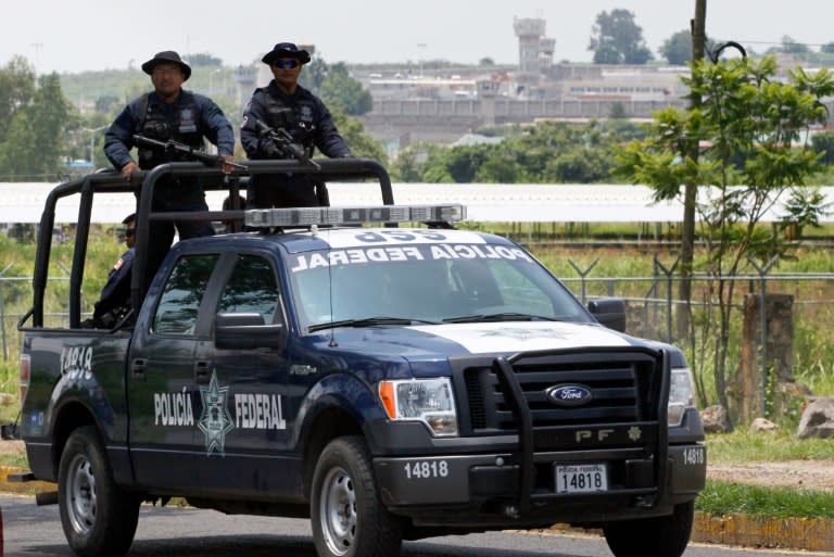 A unit of the Mexican Federal Police patrols the surroundings of the Puente Grande State prison (background) in Zapotlanejo, Jalisco State, Mexico, on August 9, 2013