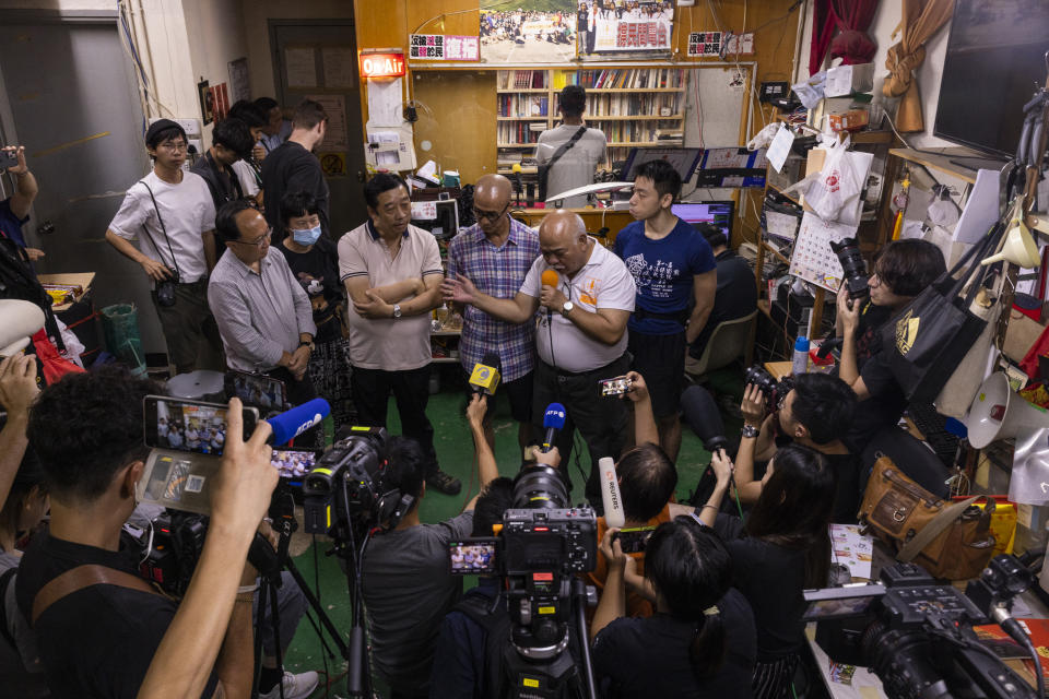 "The Bull" Tsang Kin-shing, center, founder of Hong Kong's pro-democracy Citizens' Radio station, speaks to the press prior to the radio's last broadcast in Hong Kong, Friday, June 30, 2023. (AP Photo/Louise Delmotte)