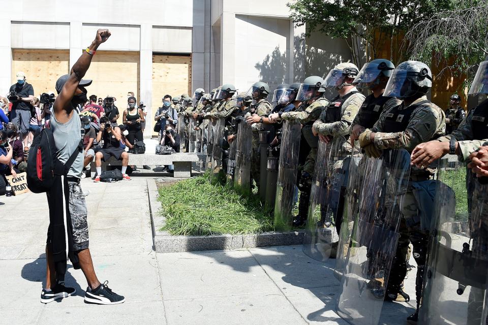 A protester faces military police near the White House to protest the death of George Floyd, on June 3 in Washington, D.C. (Photo: OLIVIER DOULIERY via Getty Images)