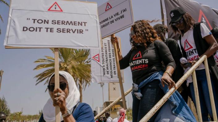 Women at a protest with placards demanding justice for Astou Sokhna.