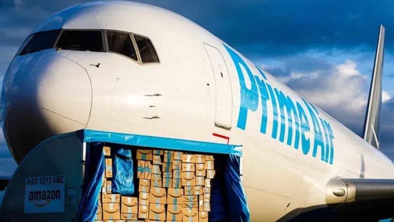 An airplane with Prime Air on its side and Amazon Prime packages in front of it.