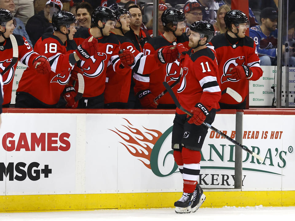 New Jersey Devils center Chris Tierney (11) is congratulated for a goal against the Colorado Avalanche during the first period of an NHL hockey game Tuesday, Feb. 6, 2024, in Newark, N.J. (AP Photo/Noah K. Murray)