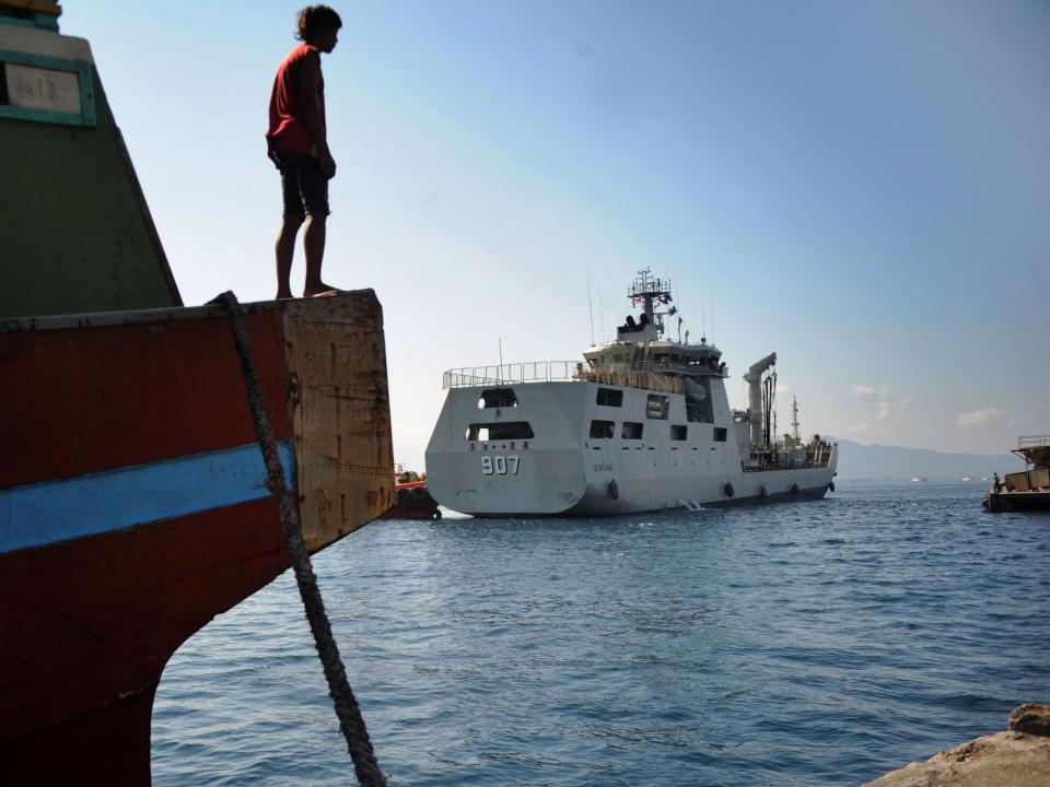 An Indonesian Navy patrol boat arrives at a naval base to aid in the search for the missing submarine.