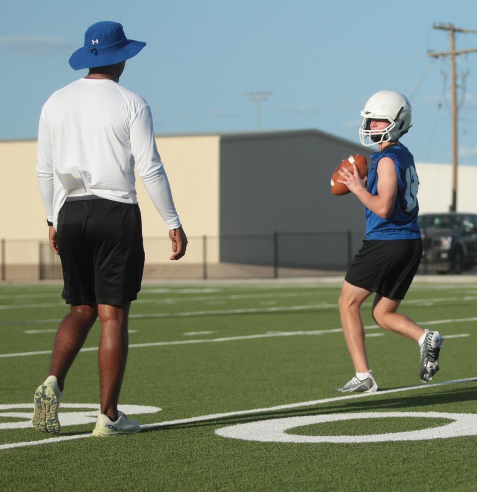 Reagan County High School's Jarrett Brown practices drop-back technique under the guidance of assistant coach Willie Rangel during football workout Monday, Aug. 1, 2022, at James H. Bird Memorial Stadium in Big Lake.