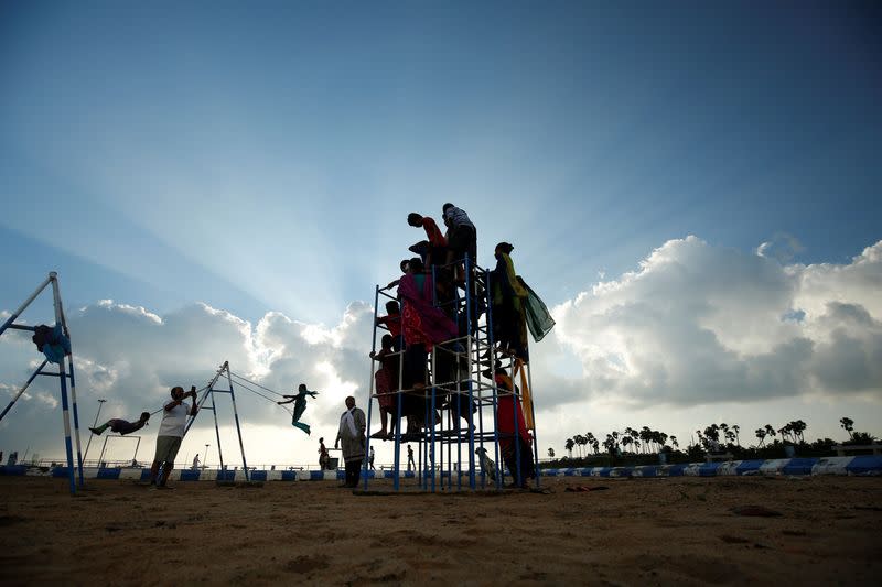 Karibeeran Paramesvaran and his wife Choodamani, who lost three children in the 2004 tsunami, take pictures of children they shelter at their care home for orphaned children in Nagapattinam district in the southern state of Tamil Nadu, India