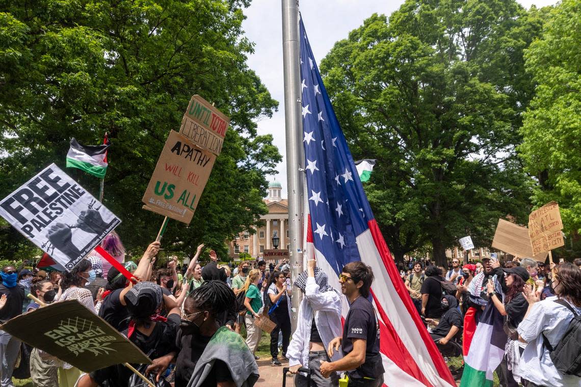 Pro-Palestinian demonstrators replace an American flag with a Palestinian flag Tuesday, April 30, 2024 at UNC-Chapel Hill. Police removed a “Gaza solidarity encampment” earlier Tuesday morning.