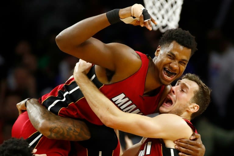 Hassan Whiteside (L) of the Miami Heat celebrates his buzzer beating game winning basket with teammate Goran Dragic while playing the Detroit Pistons, at the Palace of Auburn Hills in Michigan, on March 28, 2017