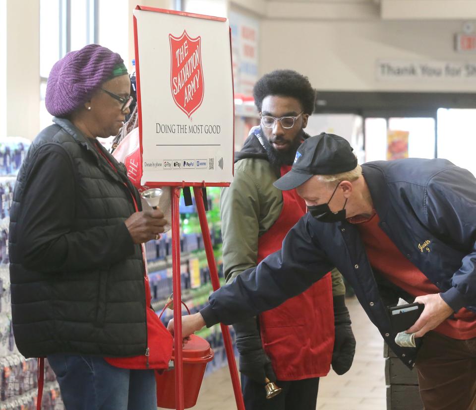 Salvation Army volunteers Diane Hill and Robert Stewart take in a donation Tuesday at the Acem Fresh Market in Montrose.