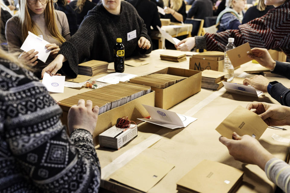 People count the advance votes of the Finnish parliamentary elections at the Kallio administrative building in Helsinki, Finland, Sunday, April 2, 2023. (Roni Rekomaa/Lehtikuva via AP)