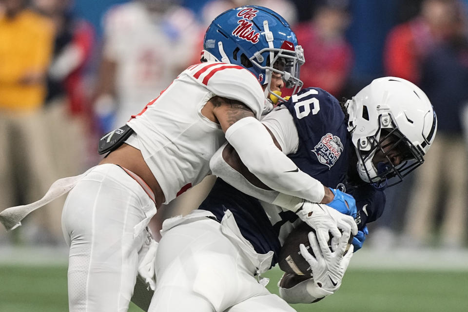 Mississippi safety Daijahn Anthony (3) hits Penn State tight end Khalil Dinkins (16) during the first half of the Peach Bowl NCAA college football game, Saturday, Dec. 30, 2023, in Atlanta. (AP Photo/Brynn Anderson)