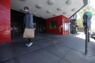 A pedestrian walks past a closed CineArts Empire theater in San Francisco