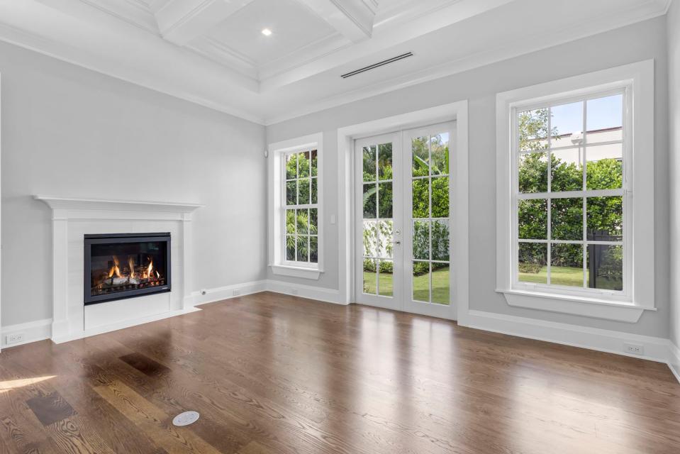 A fireplace is featured in one of the five bedrooms, which can double as an office, at a just-completed Palm Beach house at 130 Algoma Road, listed for sale at $23 million.