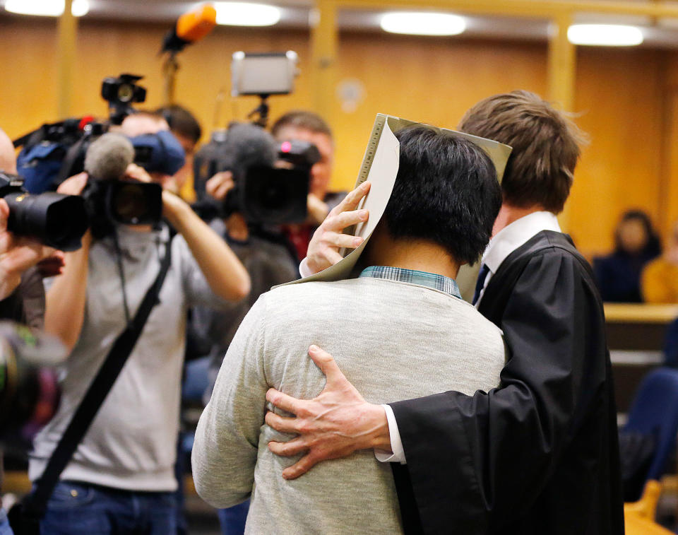 <p>A 16-year-old South Korean covers his face as he is led into a court room in Frankfurt, Germany, Feb. 20, 2017. He is the main suspect accused of murder following the death a 41-year-old woman in an apparent exorcism ritual in a Frankfurt hotel. (AP Photo/Michael Probst) </p>