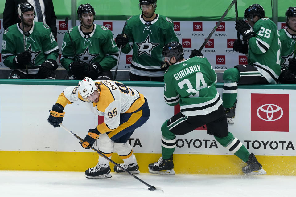 Nashville Predators center Matt Duchene (95) gains control of the puck next to Dallas Stars right wing Denis Gurianov (34) during the first period of an NHL hockey game in Dallas, Friday, Jan. 22, 2021. (AP Photo/Tony Gutierrez)