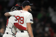 Boston Red Sox pitcher Tanner Houck (89) is embraced by catcher Connor Wong after Houck threw a three-hitter against the Cleveland Guardians in a baseball game Wednesday, April 17, 2024, in Boston. (AP Photo/Charles Krupa)