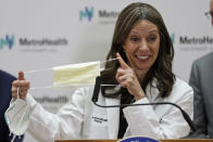 Ohio Department of Health Director Amy Acton holds up a mask as she gives an update at MetroHealth Medical Center Thursday, Feb. 27, 2020, in Cleveland, on the state's preparedness and education efforts to limit the potential spread of a new virus which caused a disease called COVID-19. (AP Photo/Tony Dejak)