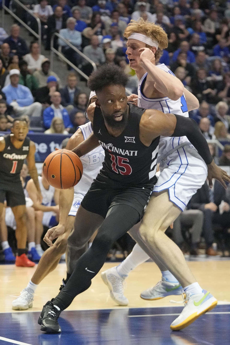 BYU guard Richie Saunders, right, guards Cincinnati forward John Newman III (15) during the first half of an NCAA college basketball Saturday, Jan. 6, 2024, in Provo, Utah. (AP Photo/Rick Bowmer)