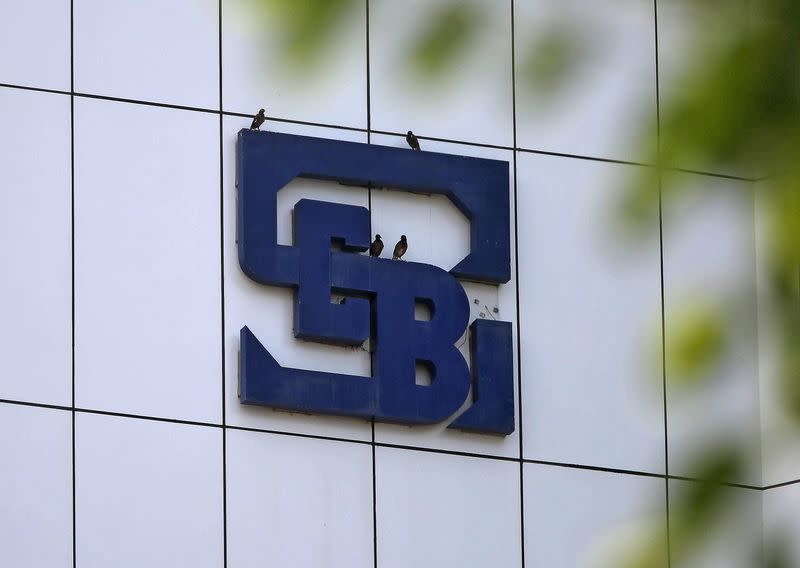 FILE PHOTO: Birds rest on the logo of SEBI installed on the facade of its head office building in Mumbai