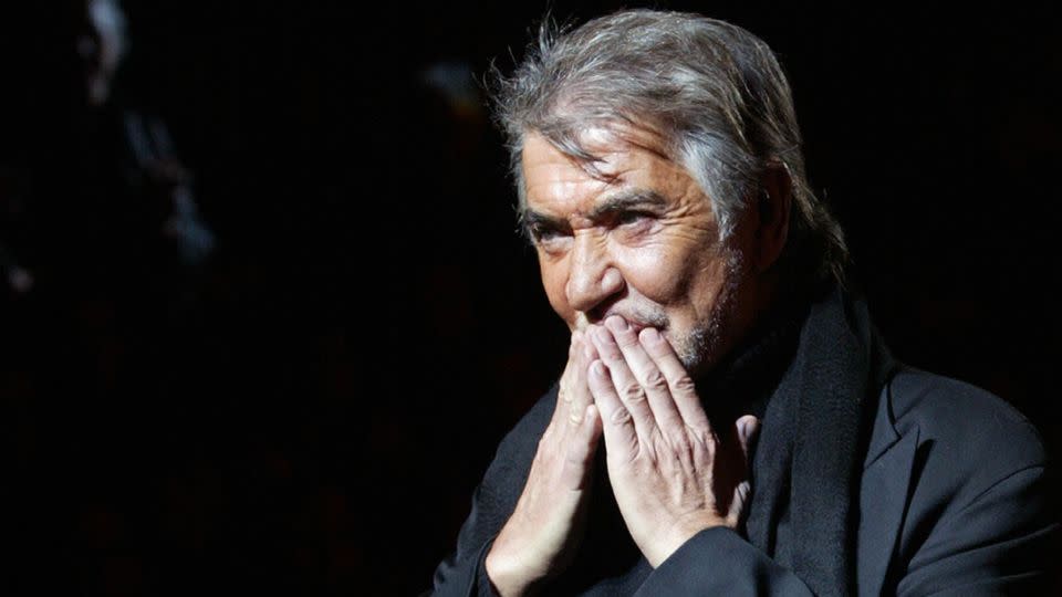Roberto Cavalli receives to applause after showing his Fall-Winter 2005 womenswear collection during Milan Fashion Week on February 27, 2004. - Francois Guillot/AFP/Getty Images