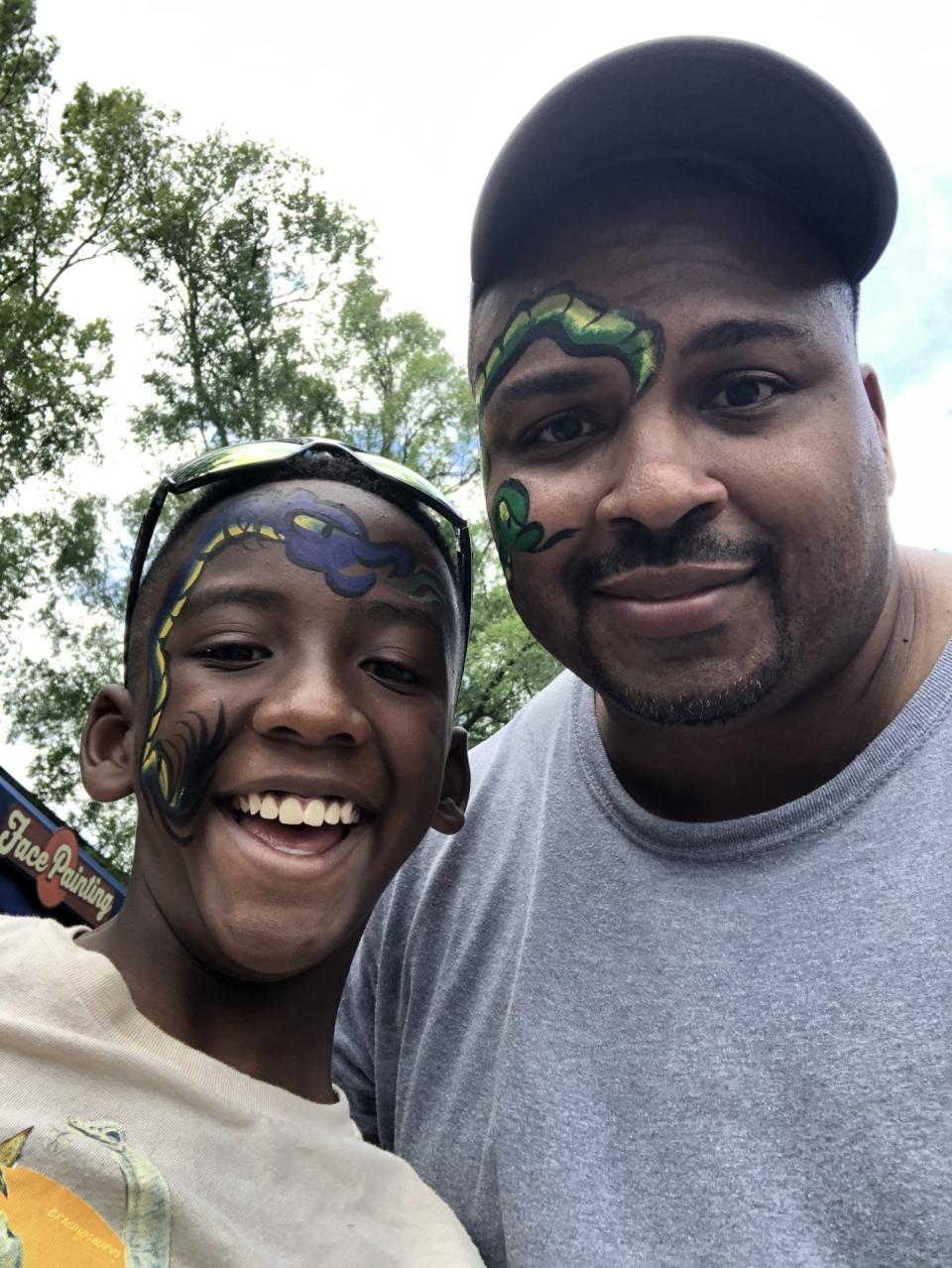 Alexander Wolley, left, poses for a photo with his father Marshawn Wolley.