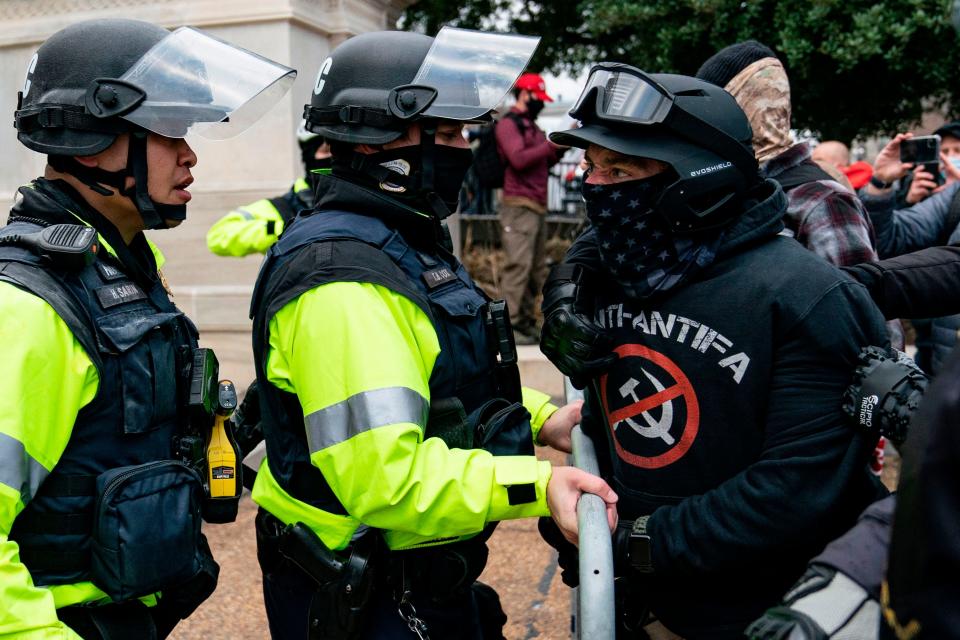 A protester, who claims to be a member of the Proud Boys, confronts police officers as supporters of former President Donald Trump protest outside the U.S. Capitol on Jan. 6, 2021, in Washington.